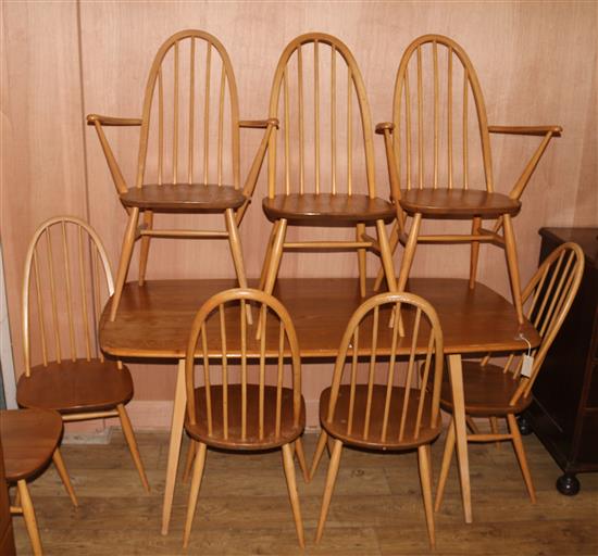An Ercol dining table and eight chairs W.153cm